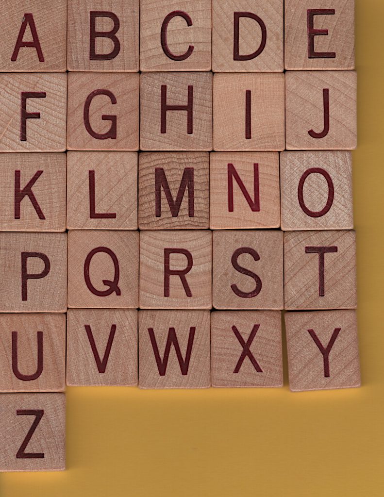 26 wooden letter tiles from SCRABBLE® Anagrams, arranged in alphabetical order